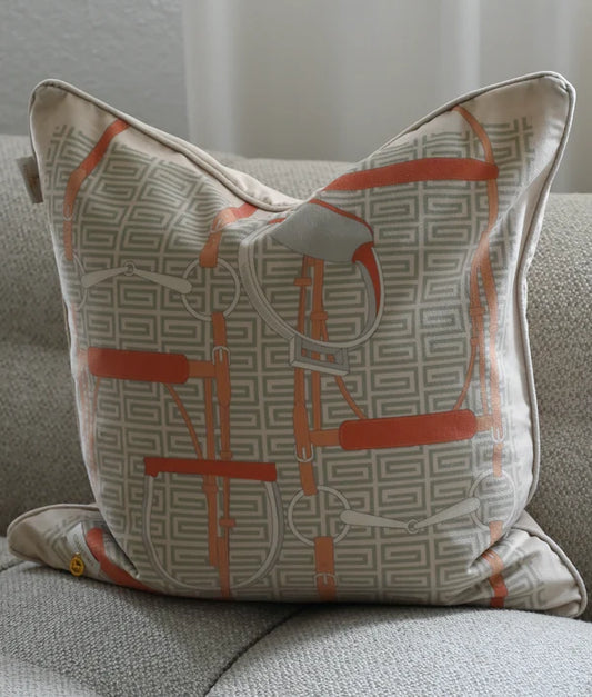 Cushion with bridle details on a grey sofa