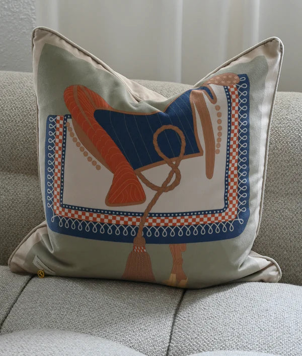 Green cushion with antique saddle design on a grey sofa