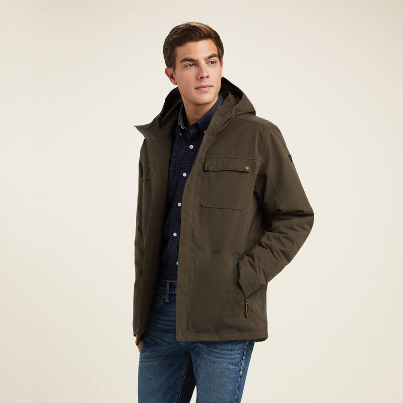 Man wearing a brown jacket with a hood on a beige background