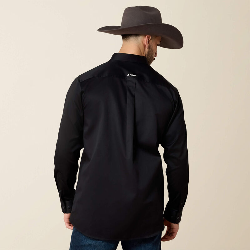 Man wearing a black shirt and brown cowboy hat on a beige background