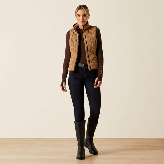 Person wearing a beige quilted vest on a beige background