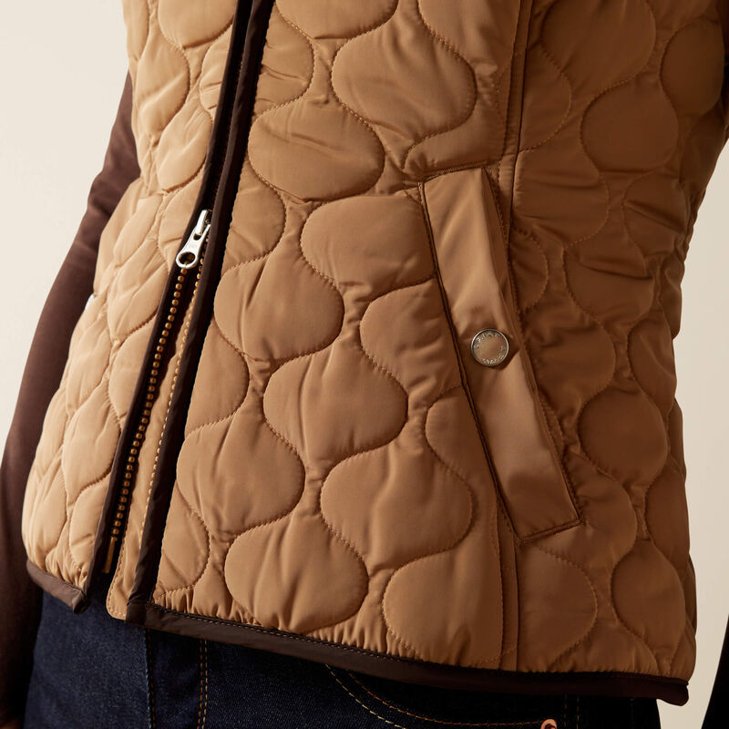 Brown quilted jacket with a zipper on a beige background