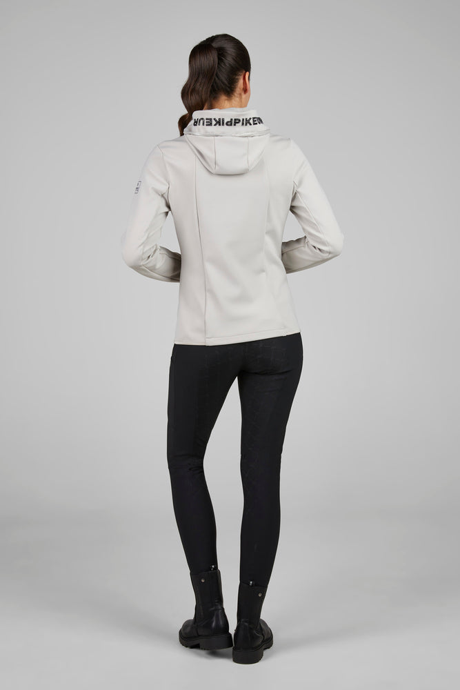 Person wearing a light gray jacket with a hood on a plain background