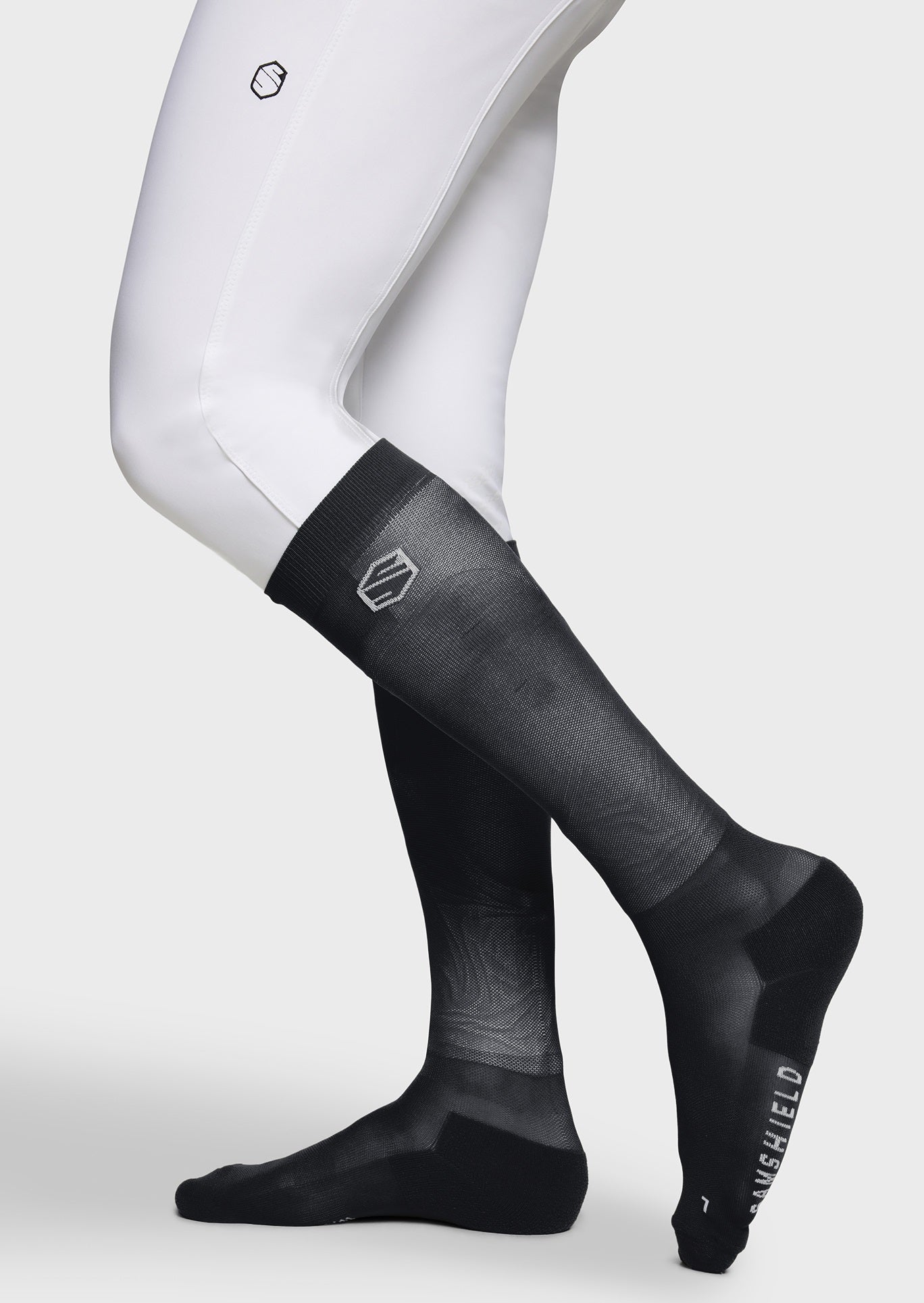Black compression socks with visible brand logo on a white background