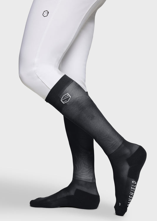 Black compression socks with visible brand logo on a white background