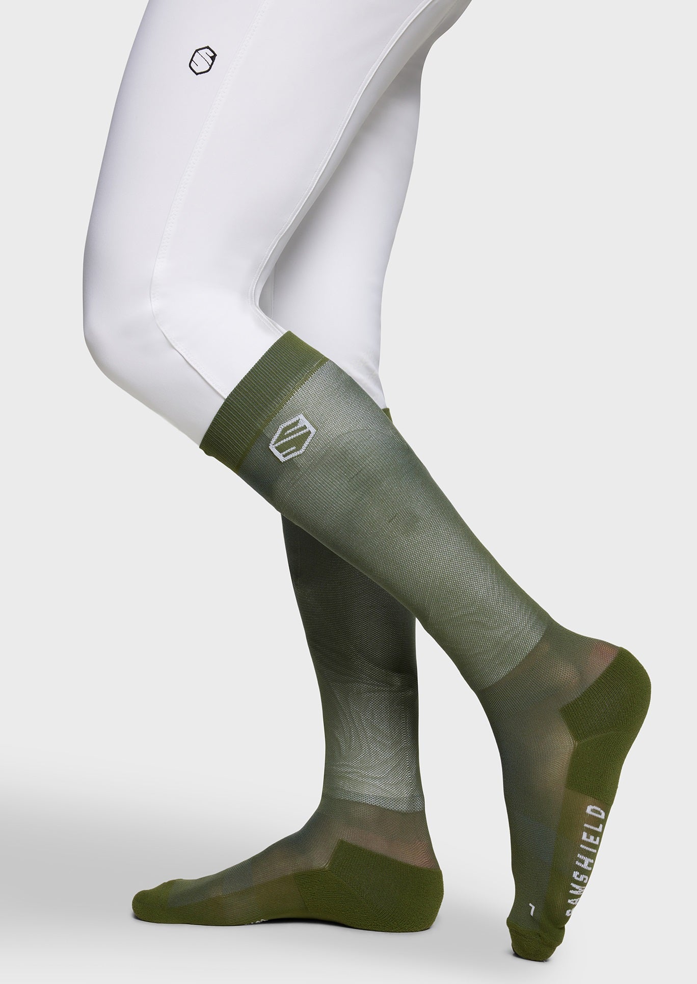 Green knee-high socks with a brand logo on a white background