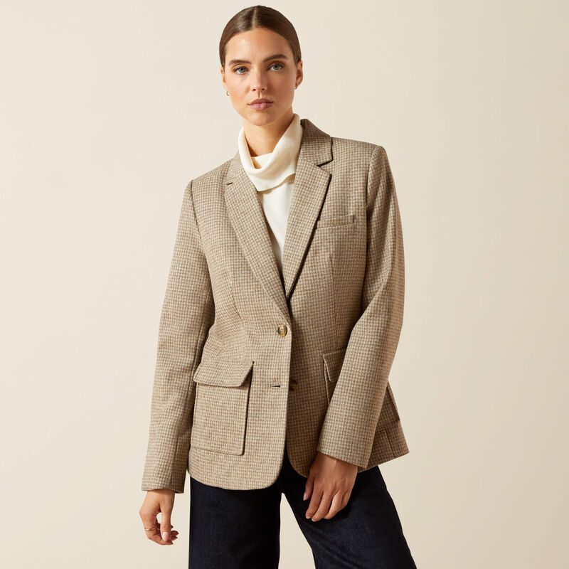 Woman wearing a beige checkered blazer over a white shirt on a beige background