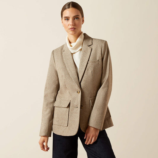 Woman wearing a beige checkered blazer over a white shirt on a beige background