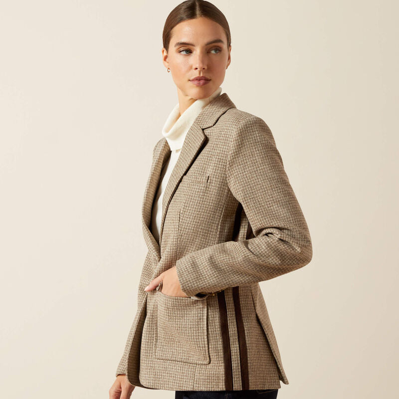 Woman wearing a checkered coat on a beige background