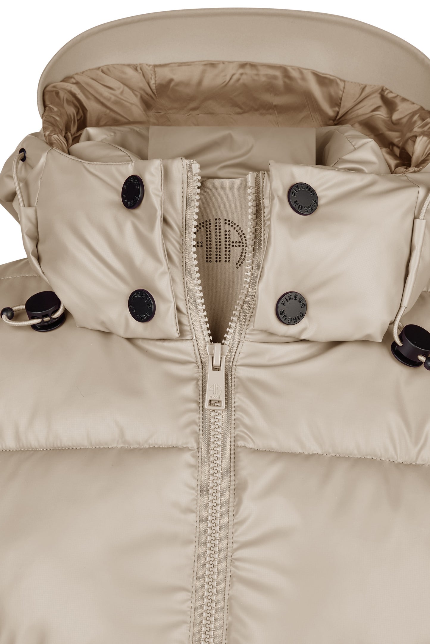 Close-up of a beige winter jacket with a zipper and button details on a white background