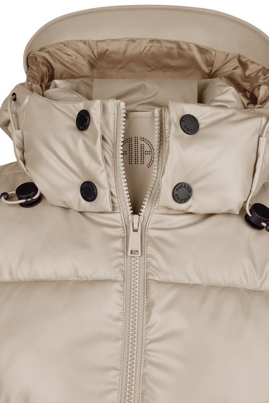 Close-up of a beige winter jacket with a zipper and button details on a white background