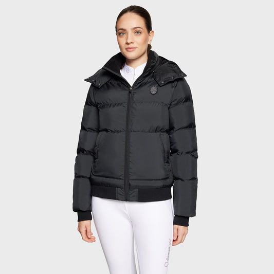 Woman wearing a black puffer jacket on a white background