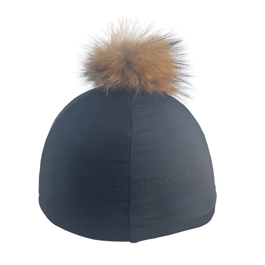 Black cap with a brown fur pom-pom on a white background