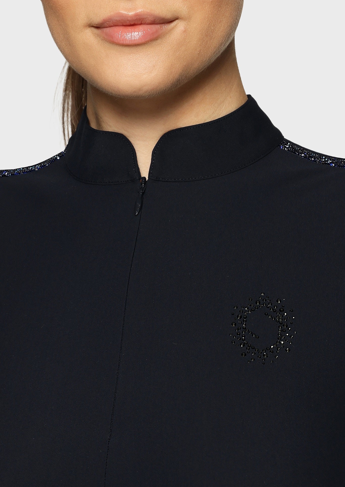 Woman wearing a navy top on a beige background