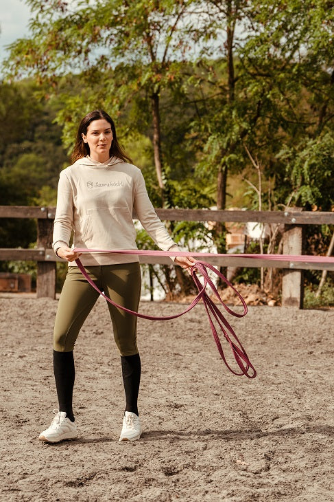 Woman holding a lunge line outdoors