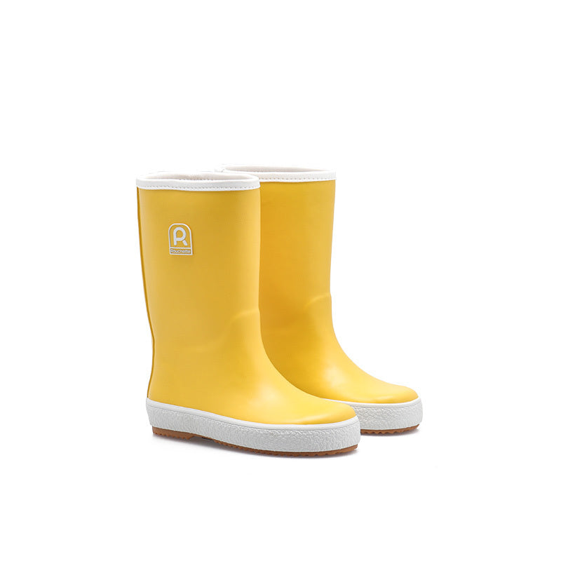 Yellow children's wellies on a white background