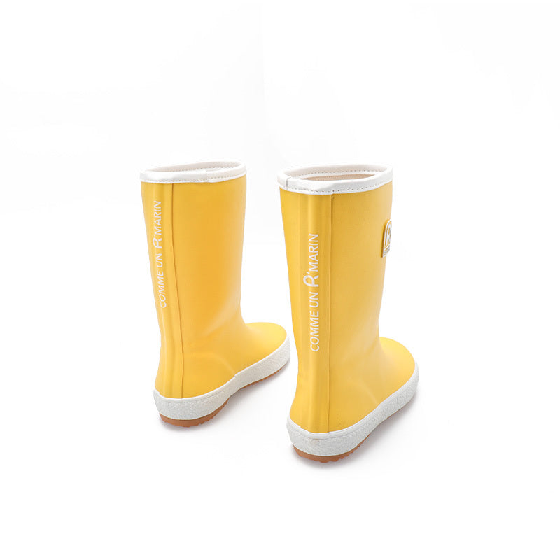 Yellow children's wellies on a white background