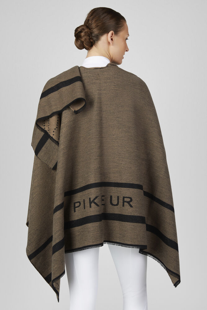 A woman shown from the back wearing a brown knit poncho with black stripes and the brand name 'PIKEUR' printed across the lower back, against a light gray studio background.