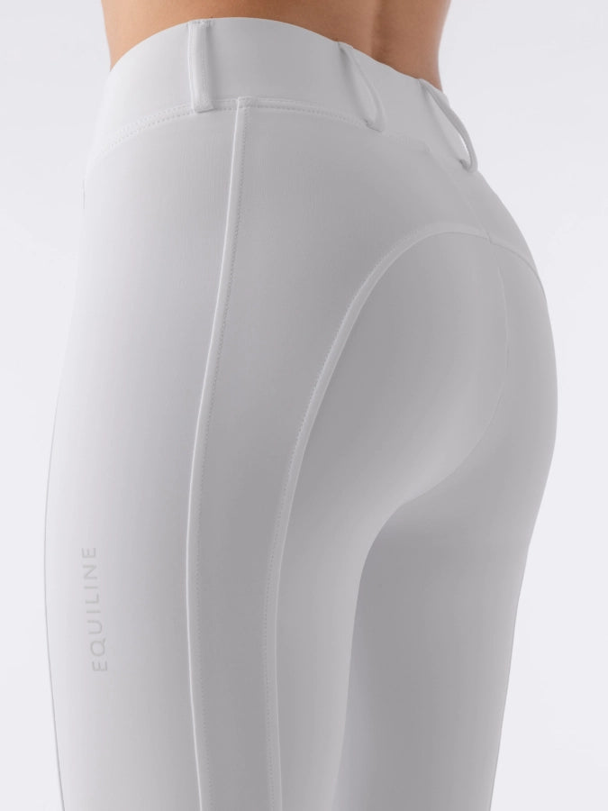 White riding pants with 'Equiline' branding on a light gray background