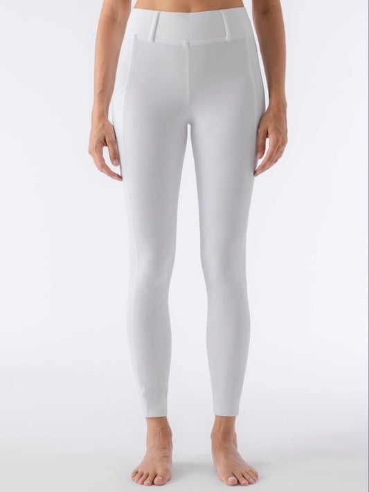 White leggings worn by a person on a white background