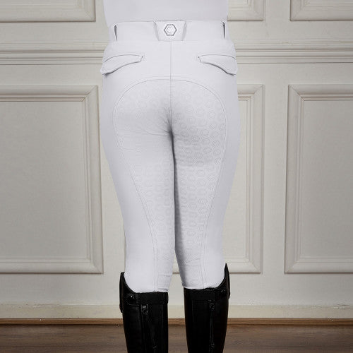White riding pants worn with black riding boots against a neutral background