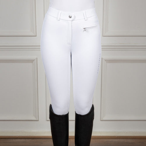 White riding pants with black boots on a neutral background