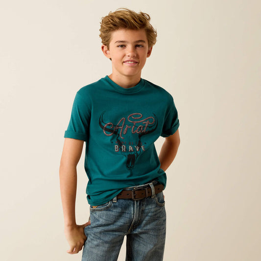 Young person wearing a teal t-shirt with 'Ariat' branding on a beige background