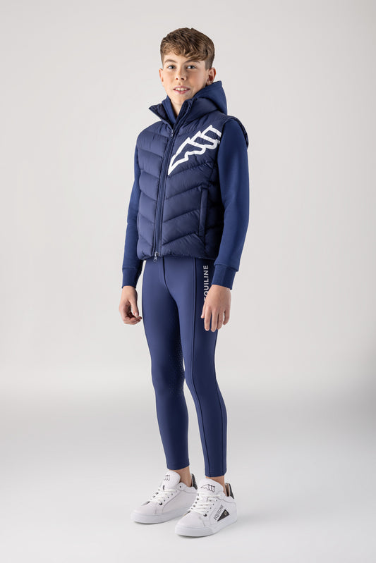 Person wearing a blue puffer jacket and pants on a white background