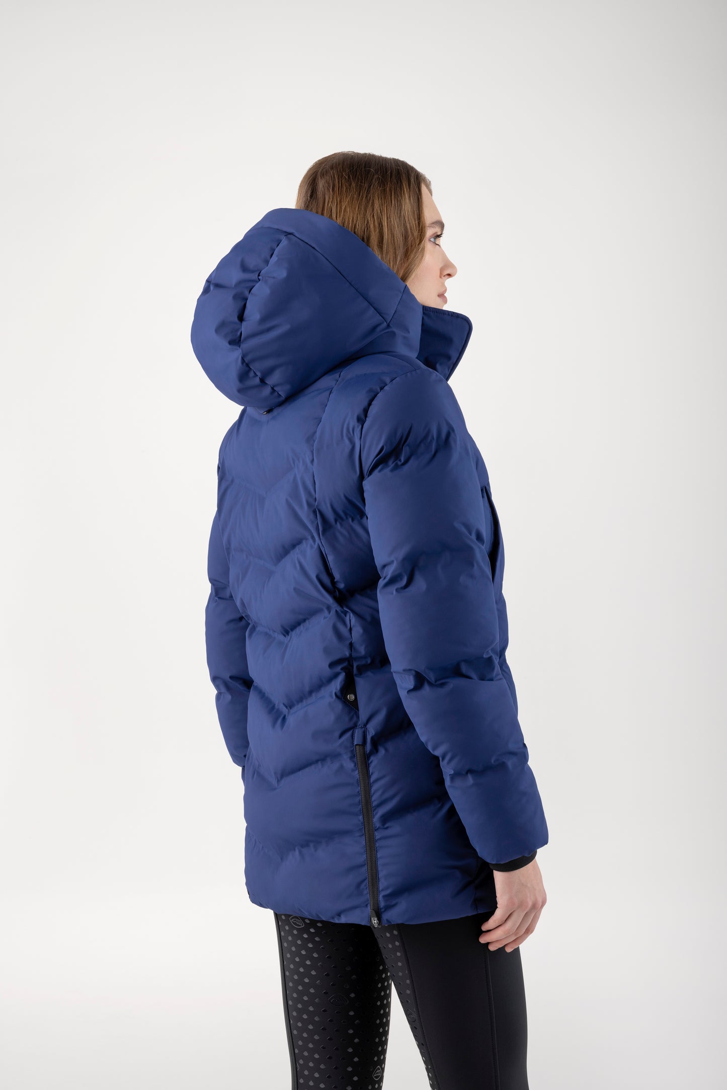Person wearing a blue puffer jacket on a white background