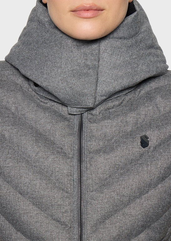 Close-up of a person wearing a heather gray puffer jacket with a high folded collar and a small black logo on the chest.