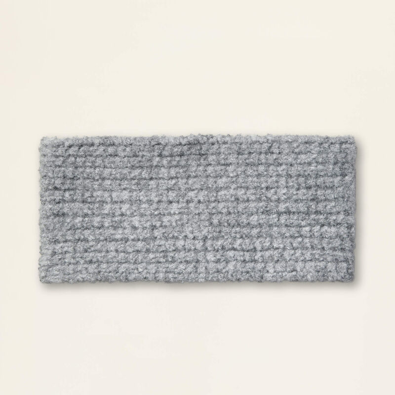 Gray knitted headband on a beige background