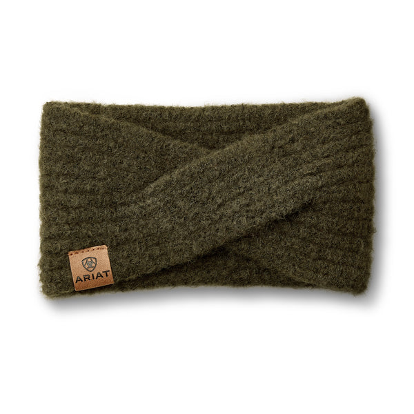 An olive green fuzzy knit wrap headband with a small brown leather brand patch on the bottom left, shown on a white background.