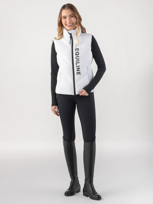 Woman wearing a white and black Equiline vest on a white background