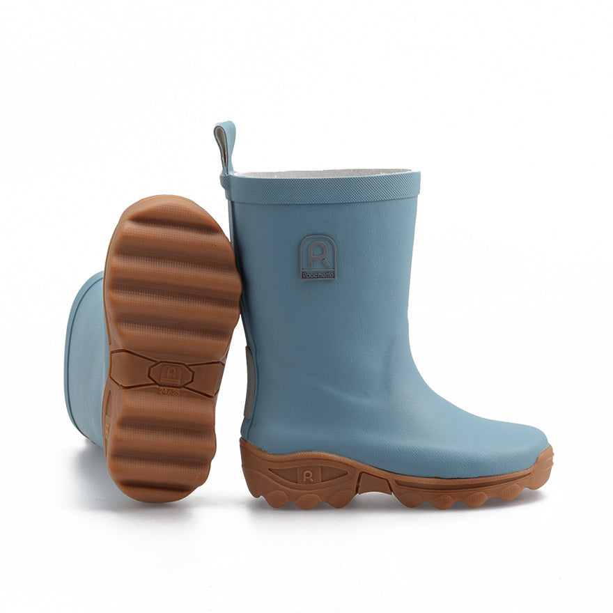 Light blue rain boots with brown soles on a white background