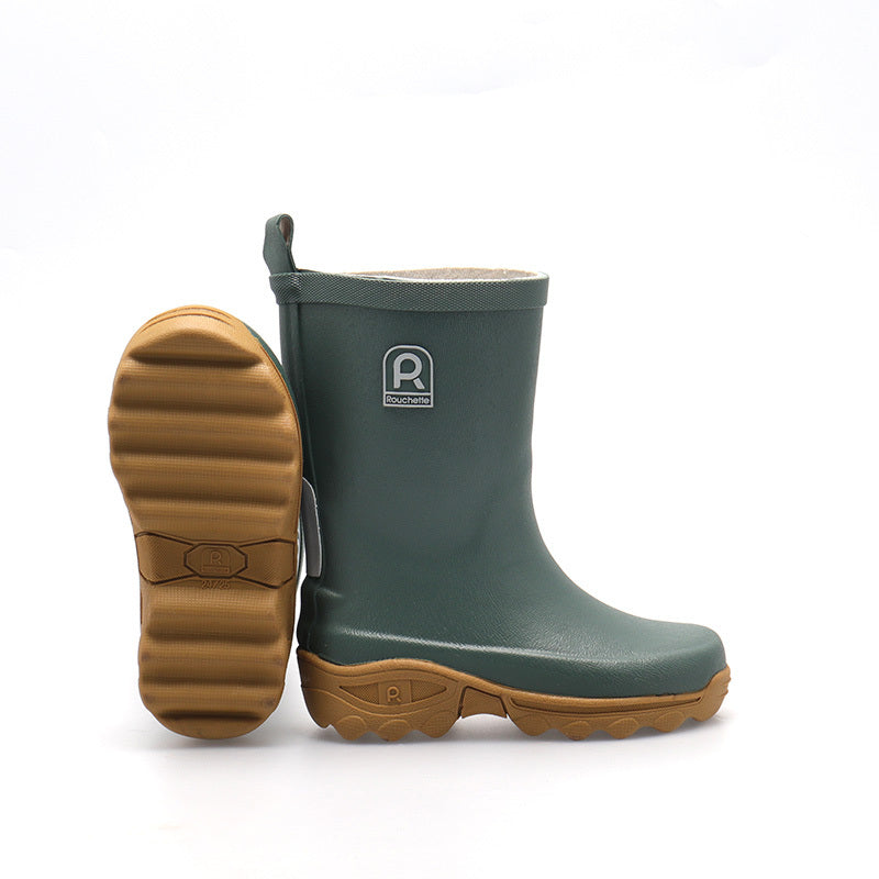 Green rubber boot with brown sole on a white background