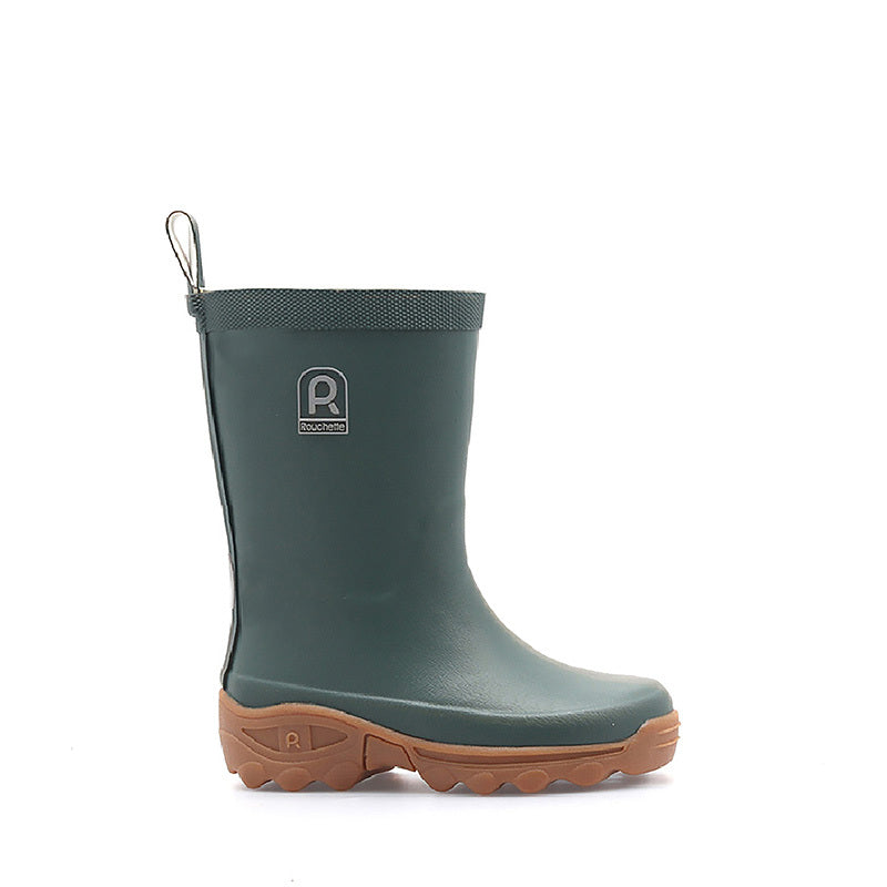 Green rain boot with brown sole on a white background