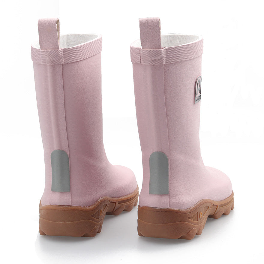 Pair of pink kids wellington boots on a white background