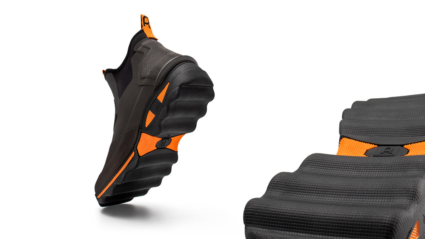 Pair of brown and orange ankle boots on a white background