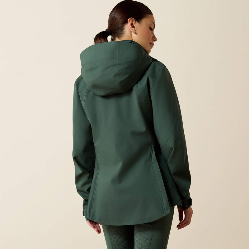 Person wearing a green raincoat on a beige background