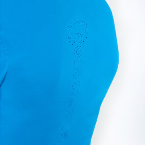 Close-up of a bright blue athletic top with a subtle tonal dotted hexagon logo and vertical 'GOLD' text on the upper chest, set against a plain white background.