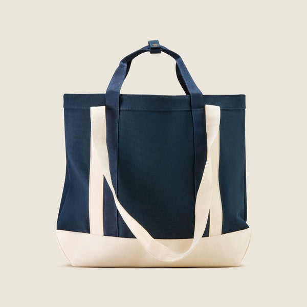 Navy tote bag with white accents on a beige background
