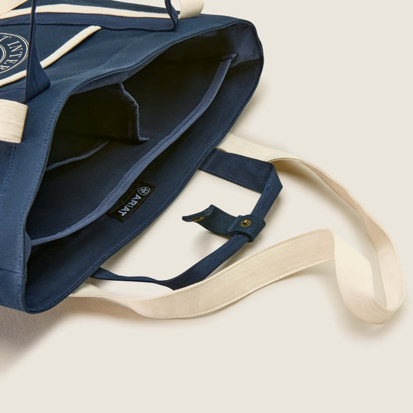 Blue bag with a beige strap on a light background