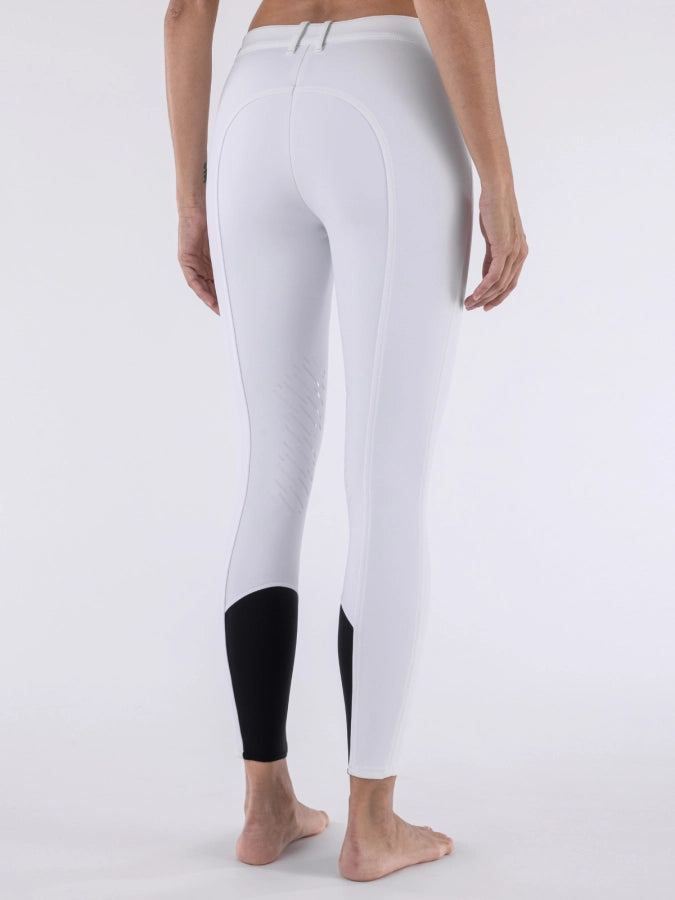 White leggings with black accents worn by a person on a white background