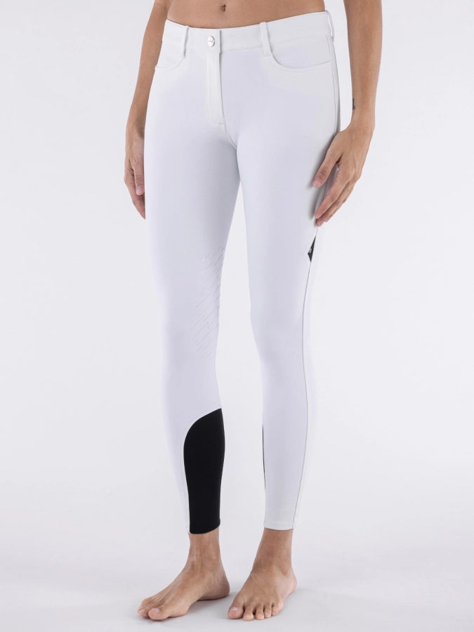 White riding pants with a black patch on a white background