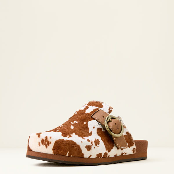 Brown and white cow print sandal with a strap on a beige background