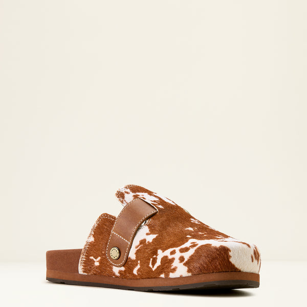 Brown and white cow print sandal on a beige background