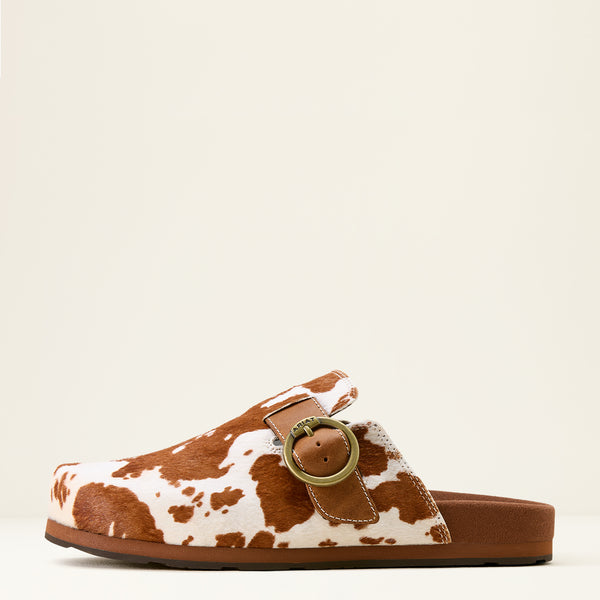 Brown and white cow print sandal with a gold buckle on a beige background