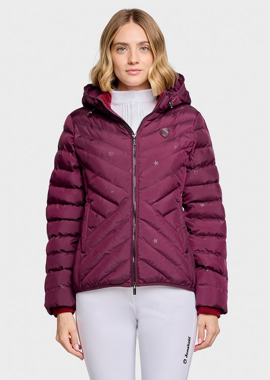 A woman modeling a quilted puffer jacket in deep burgundy with a small star pattern, shown against a plain light gray studio background.