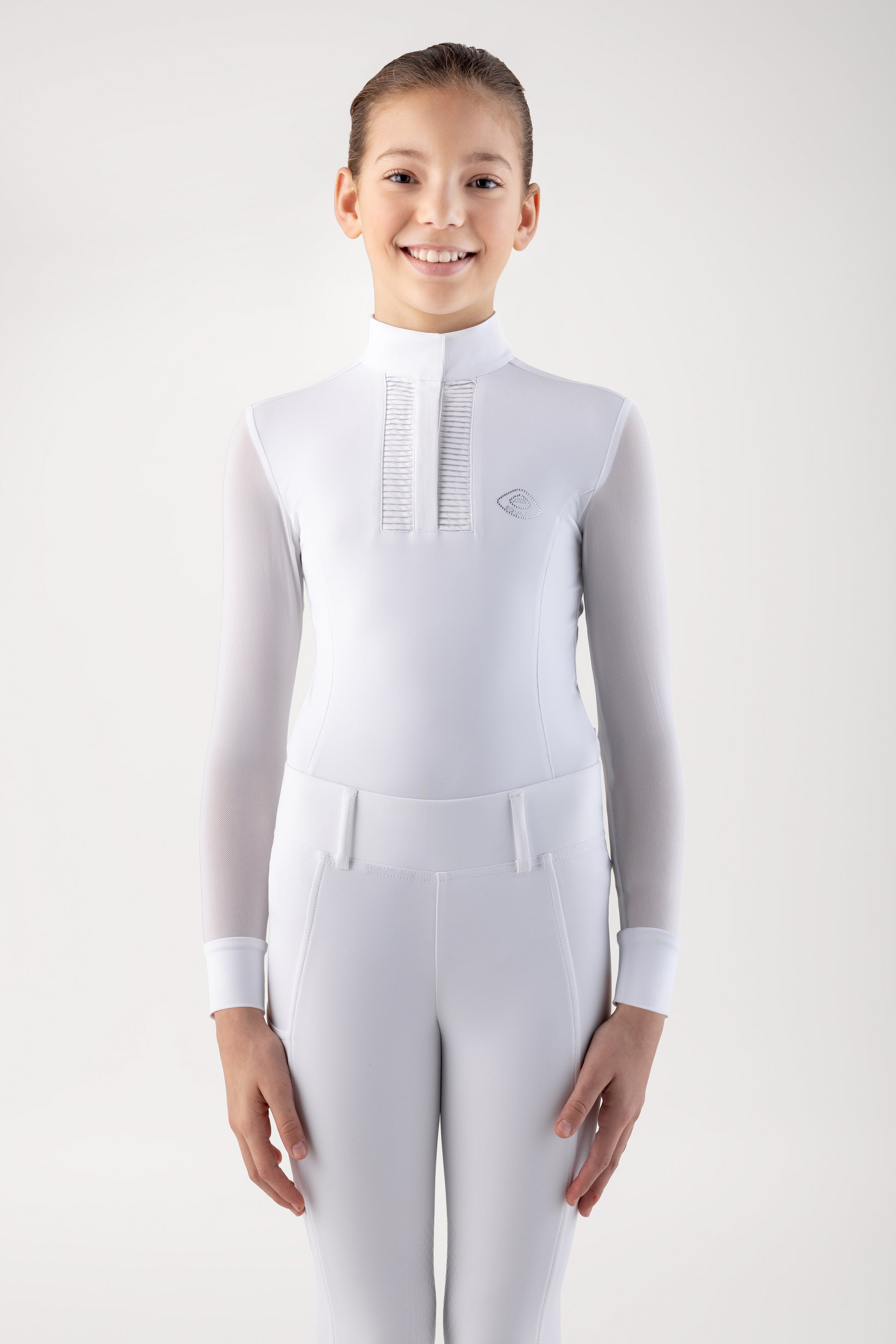 Person wearing a white equestrian suit on a plain background