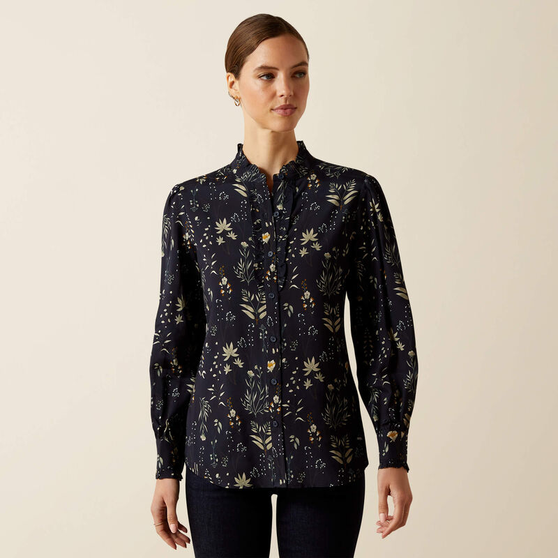 Woman wearing a dark floral patterned shirt on a beige background